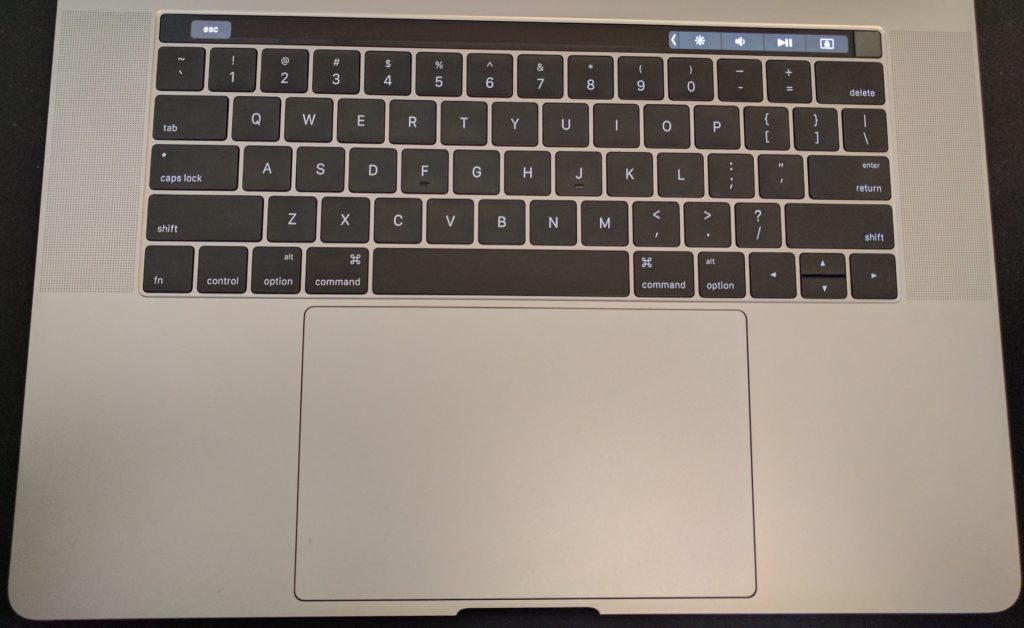 An overhead view of the keyboard, trackpad, and Touch Bar