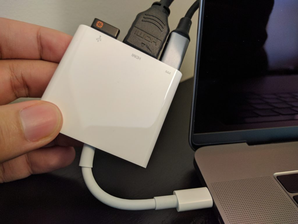 Apple's three-port adapter connected to the MacBook Pro